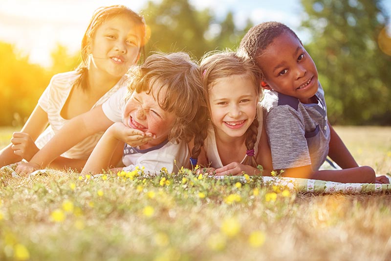 Children smiling out in the yard